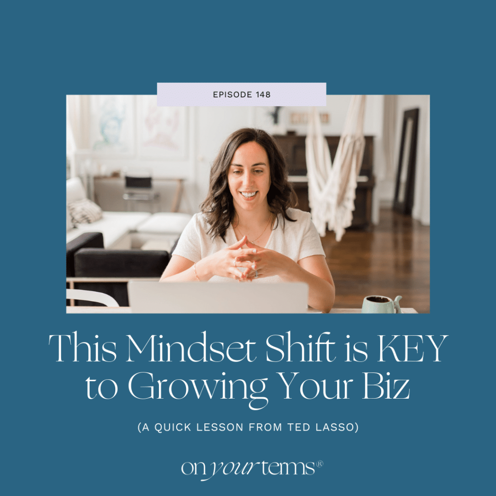 woman sitting in front of laptop with text overlay "This Mindset Shift is KEY to Growing Your Biz (A Quick Lesson from Ted Lasso)"