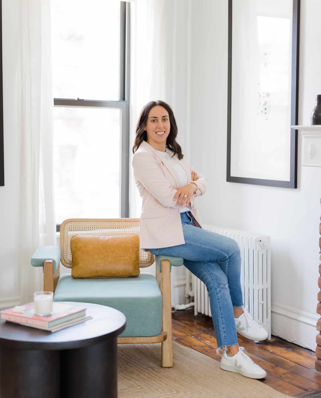 woman standing and leaning against a chair