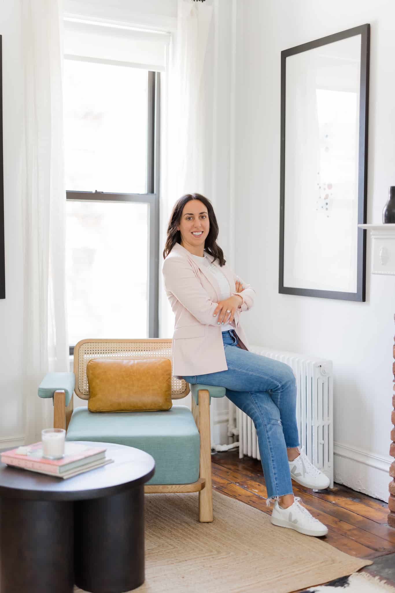 woman standing and leaning against a chair