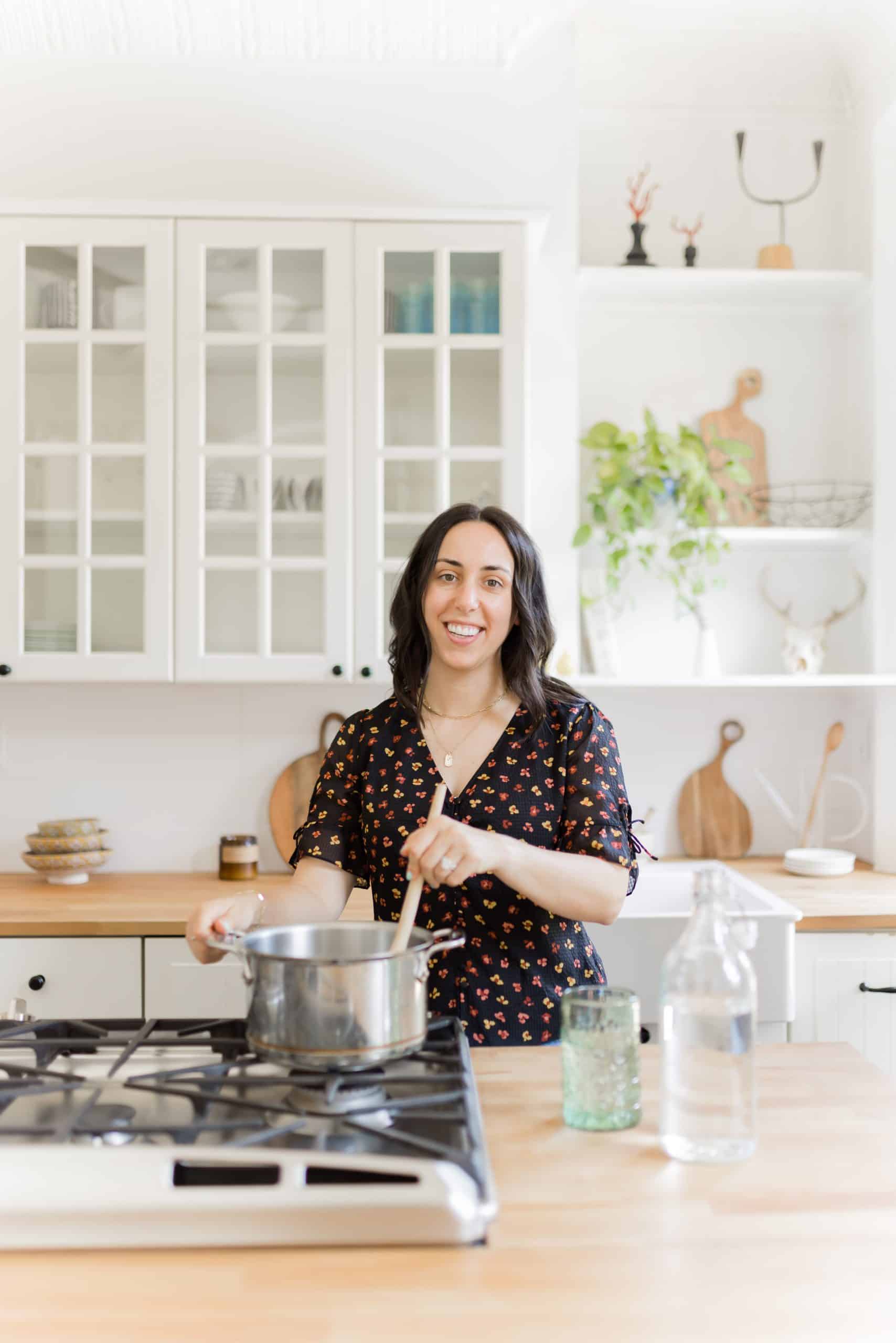 woman with dark hair cooking in a kitchen