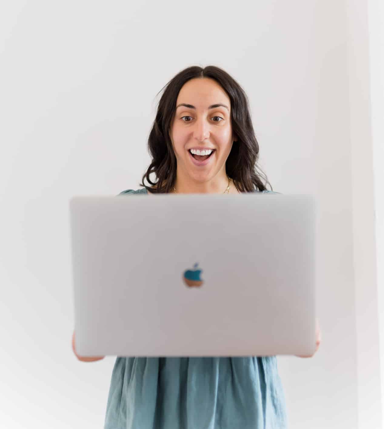 woman standing and holding a laptop