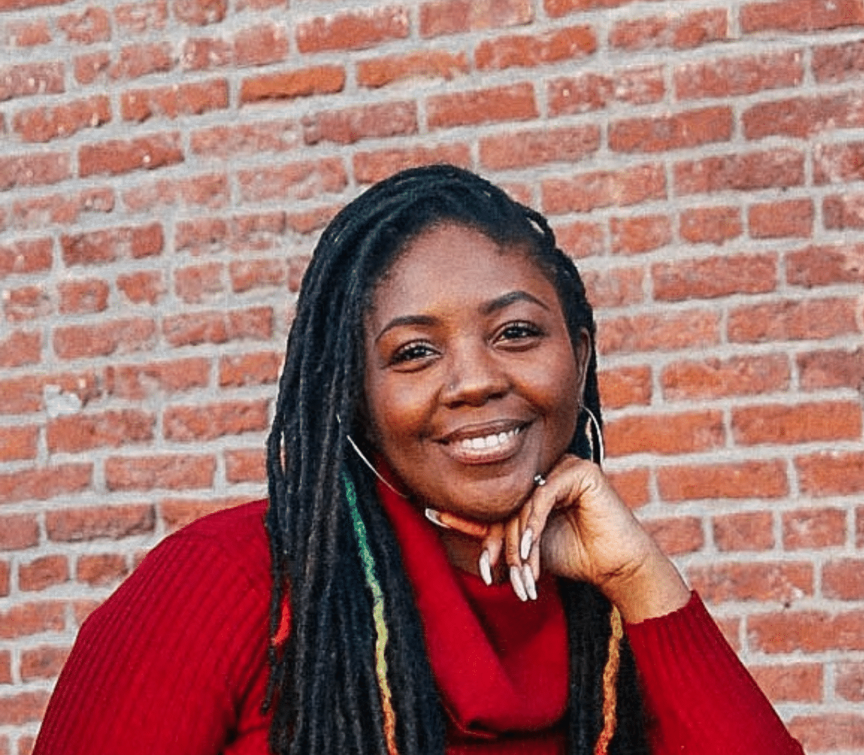 woman with long black hair and smiling