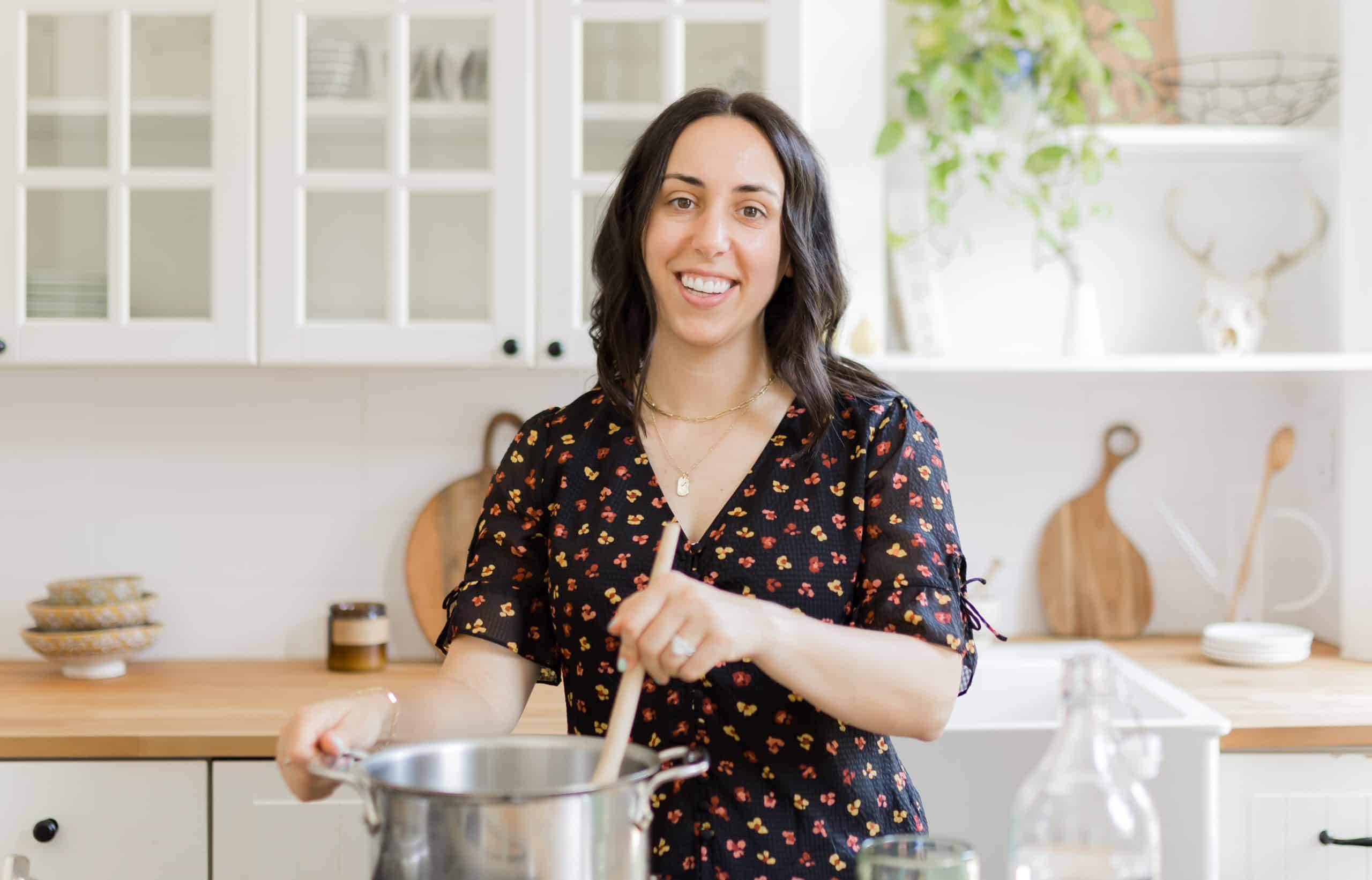 woman with dark hair cooking in a kitchen