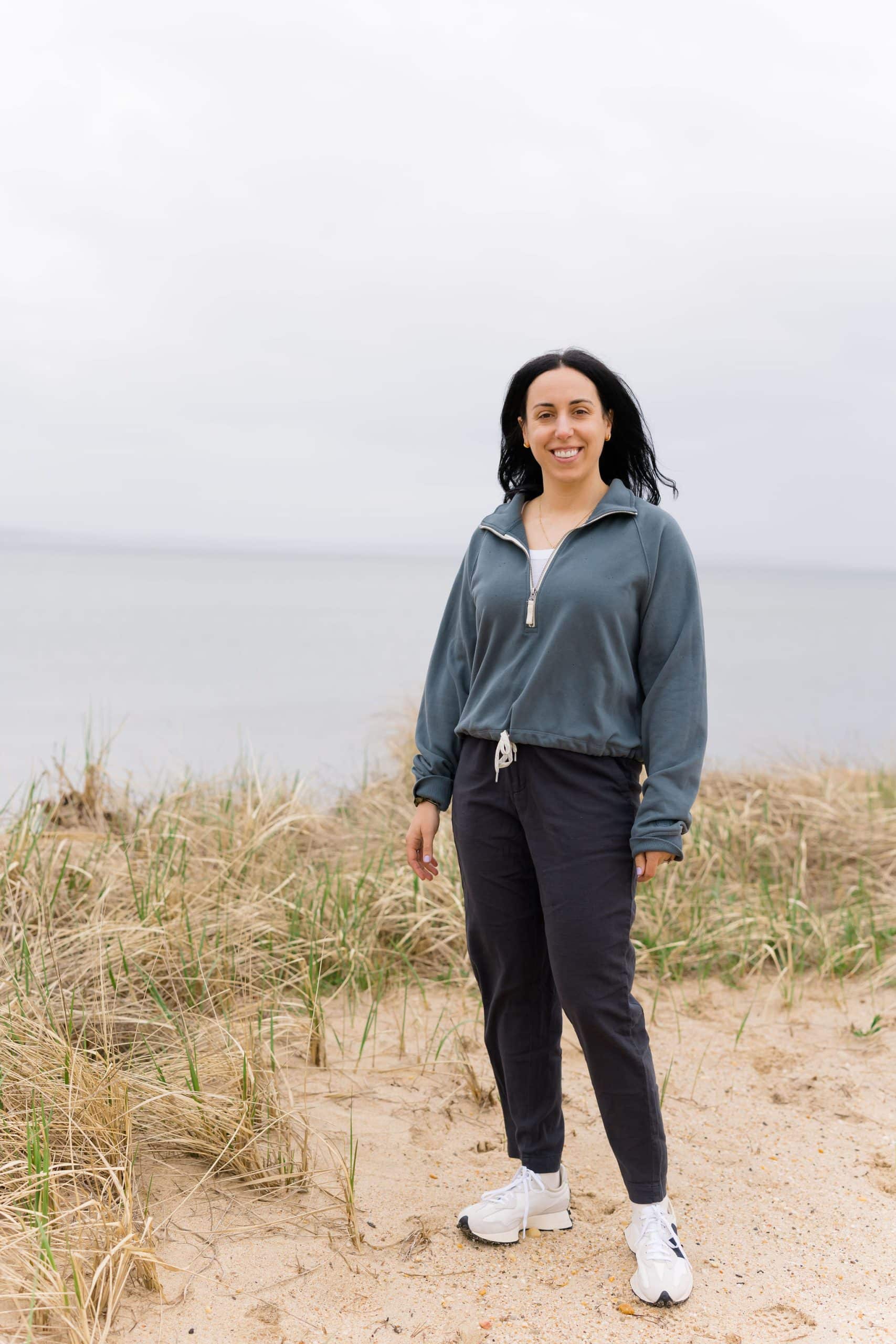 woman with dark hair standing at the beach